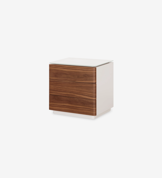 Bedside table with 3 drawers in natural walnut, pearl-lacquered structure and glass top. 