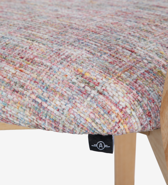 Cadeira de madeira, com pormenor de rattan nas costas e assento estofado a tecido multicolor, primariamente magenta.