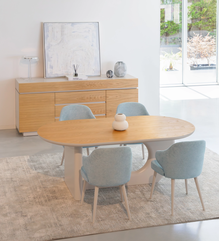 Oval dining table with natural oak top and pearl-lacquered base.