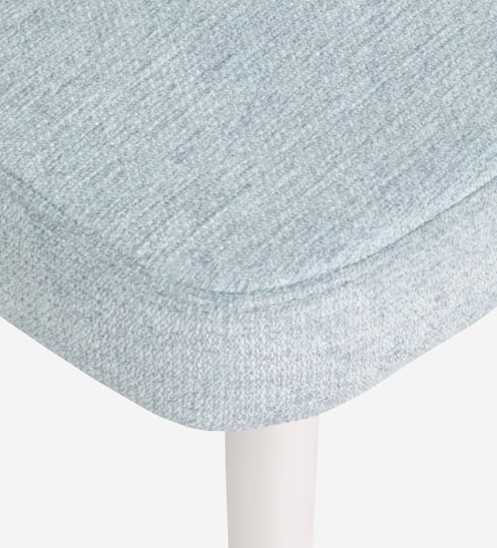 Chair upholstered in blue fabric, feet lacquered in pearl.