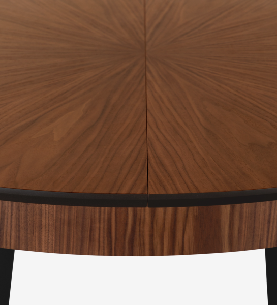 Round extendable dining table with natural walnut top and black lacquered legs.