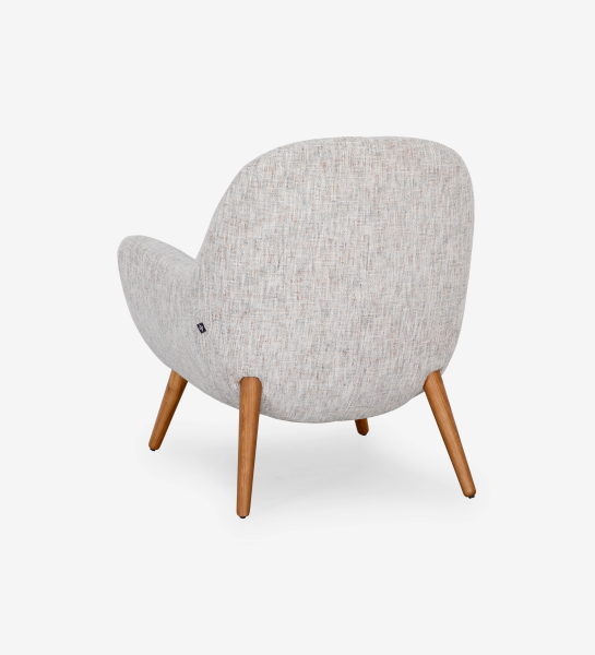 Oslo armchair upholstered in grey velvet-like fabric, with honey-coloured ash wood legs.