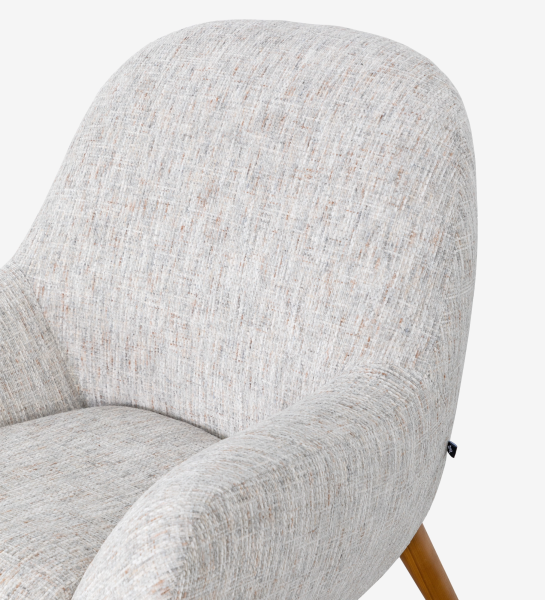 Oslo armchair upholstered in grey velvet-like fabric, with honey-coloured ash wood legs.
