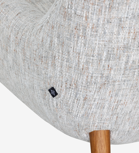 Oslo armchair upholstered in grey velvet-like fabric, with honey-coloured ash wood legs.