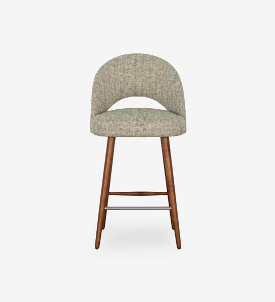 Stool upholstered in green fabric, with walnut-colored wood leg.