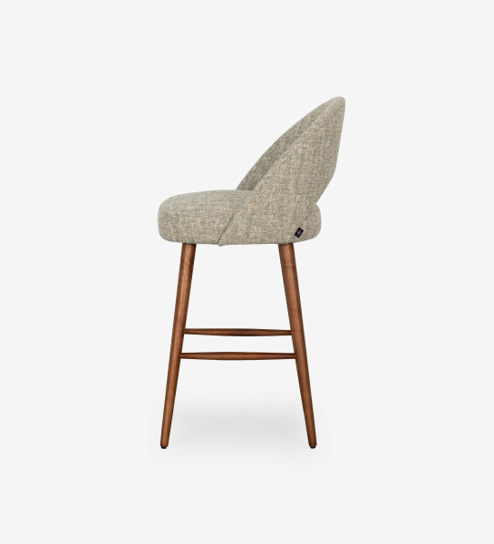 Stool upholstered in green fabric, with walnut-colored wood leg.