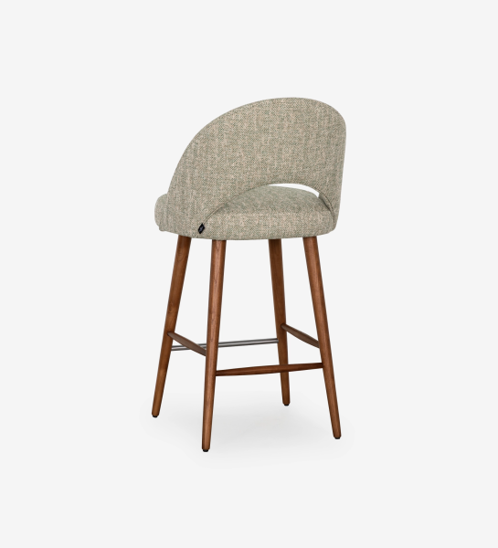 Stool upholstered in green fabric, with walnut-colored wood leg.