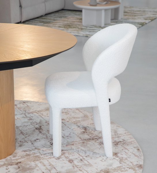 Chair upholstered in white fabric.