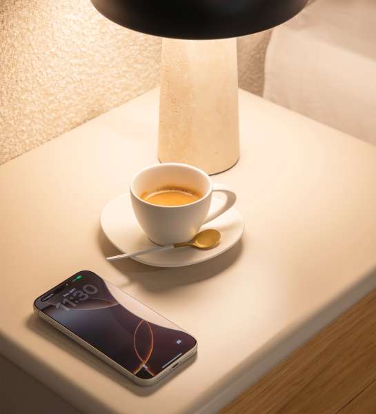 Paris Bedside Table top with black smartphone on white rounded surface and wooden drawer front