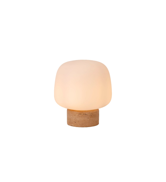 Table lamp with beige stone base and opal glass lampshade.