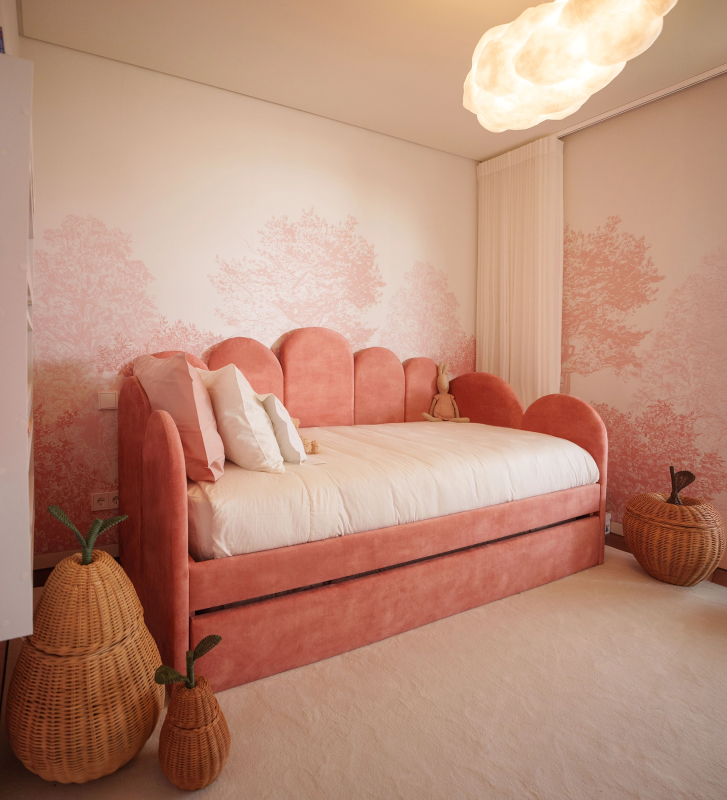 Divan Bed with upholstered frame and front in pink fabric, featuring a bed in the lower drawer.