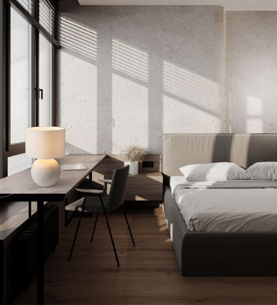 Lagos Table Lamp on wooden desk beside bed in sunlit modern bedroom