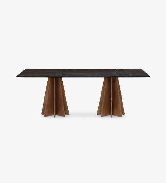 Lagos Dining Table with dark stone top and two sculptural wooden pedestal bases