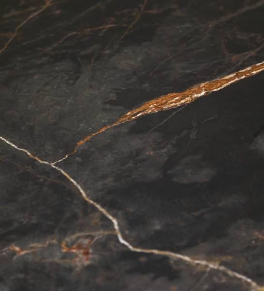 Lagos Dining Table close-up of black marble top with gold and white veining