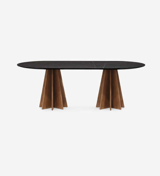 Table Lagos ovale, plateau noir marbré et deux pieds en bois sculpté