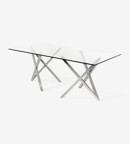 Rectangular dining table with glass top and stainless steel legs.