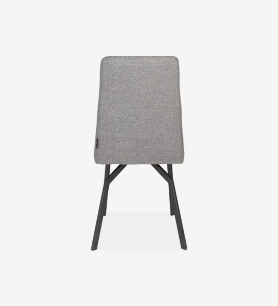 Fabric upholstered chair with black lacquered metal feet.