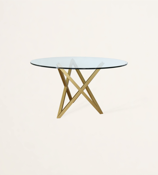 Mesa de comedor redonda con tablero de cristal y pie de metal lacado en oro.