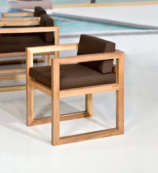 Chair with arms, fabric upholstered cushions, and natural wood structure.