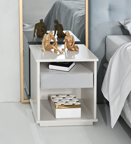 Bedside table with 1 drawer with fabric upholstered front, pearl lacquered frame.