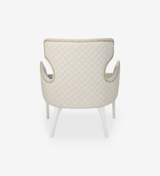 Armchair upholstered in fabric, with golden batting and pearl lacquered feet.