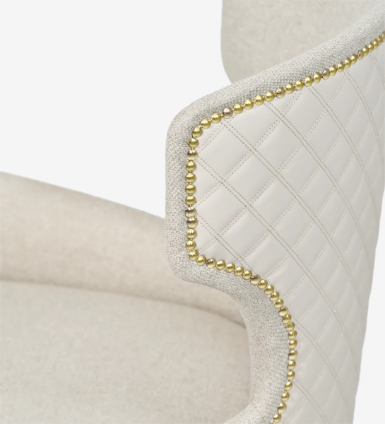 Armchair upholstered in fabric, with golden batting and pearl lacquered feet.
